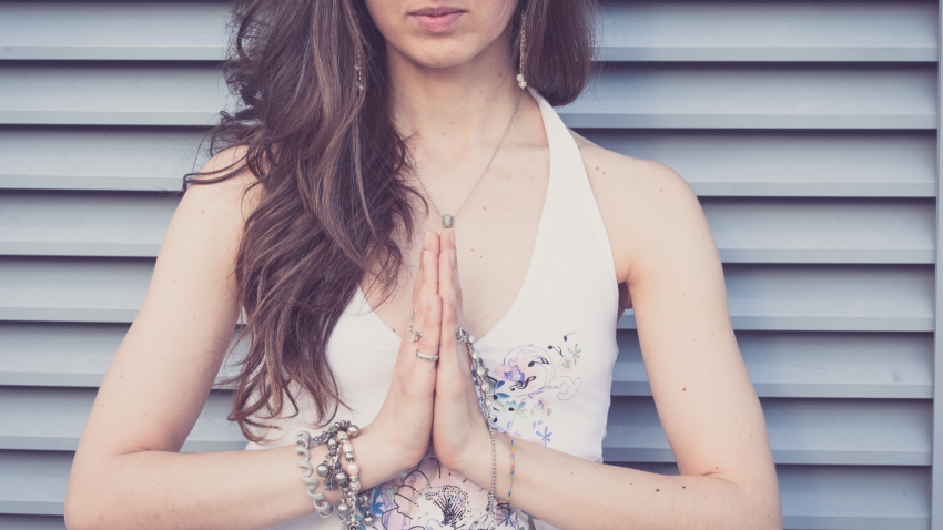 Woman practicing seva, yoga namaste pose