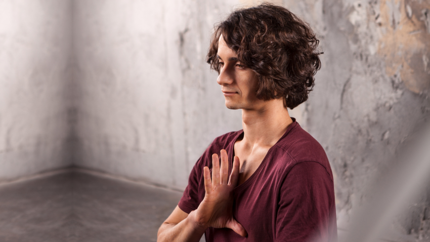 man finding calm in meditation pose Man finding calm in meditation pose