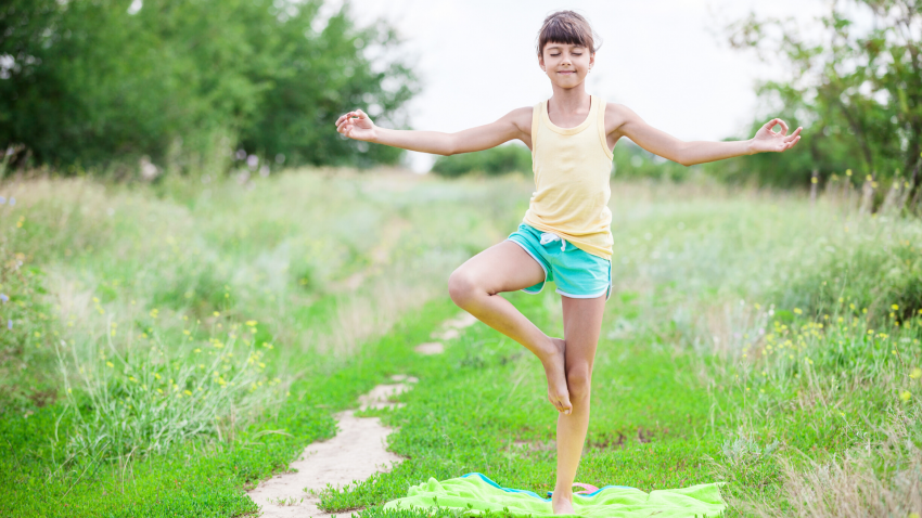 Child practicing yoga Tree Pose (Vrksasana)