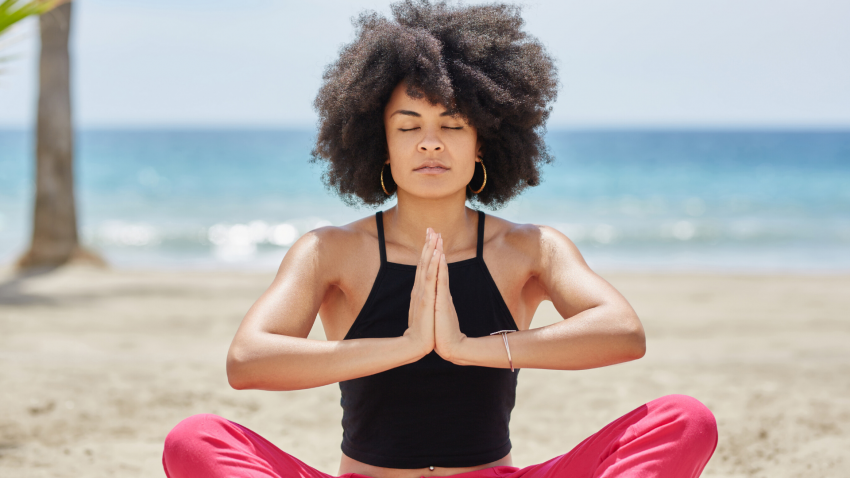 Woman practicing yoga for steadiness in Seated Pose Woman practicing yoga for steadiness in Seated Pose