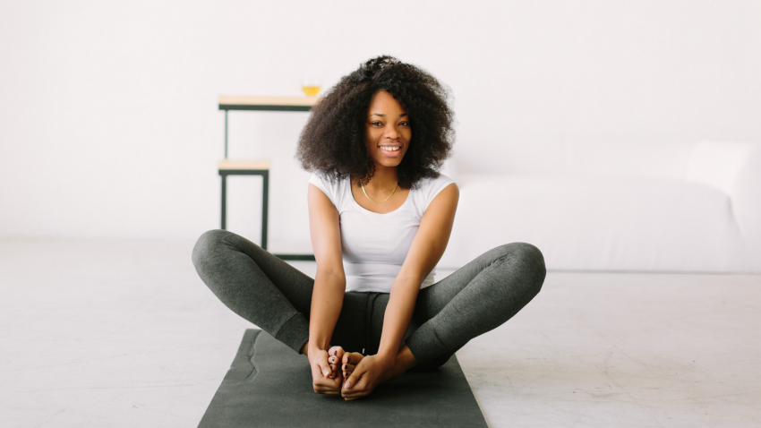 Young woman practicing yoga Bound Angle Pose (Baddha Konasana)
