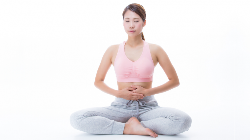 Woman practicing belly breathing yoga