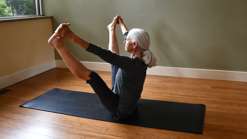 Woman practicing yoga upward facing wide leg forward bend, Urdhva Mukha Prasarita Padottanasana woman practicing yoga upward facing wide leg forward bend