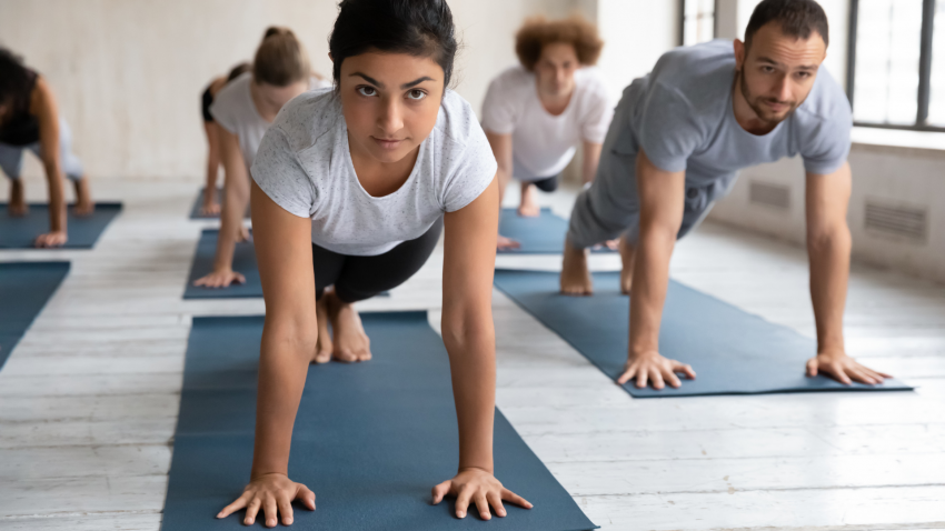 Yoga class practicing Plank Pose (Phalakasana) 