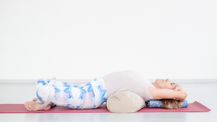 Older yoga woman in Reclining Bound Angle Pose (Supta Baddha Konasana) Older yoga woman in Reclining Bound Angle Pose (Supta Baddha Konasana)