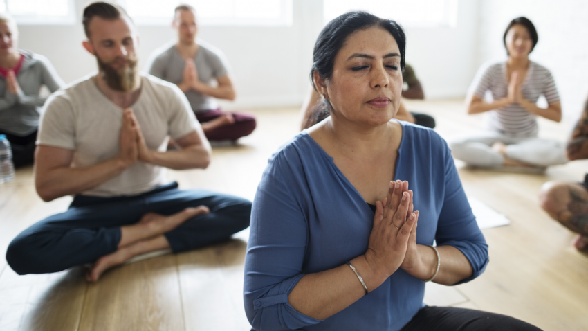 Yoga class practicing soothing poses for fibromyalgia pain