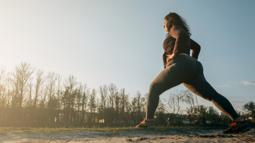 Woman practicing outdoor yoga in a Lunge Pose Woman practicing outdoor yoga in a Lunge Pose
