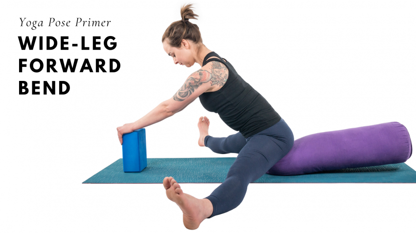 woman practicing upavista konasana, wide-leg forward bend yoga pose with block and bolster props adaptation woman practicing upavista konasana, wide-leg forward bend yoga pose