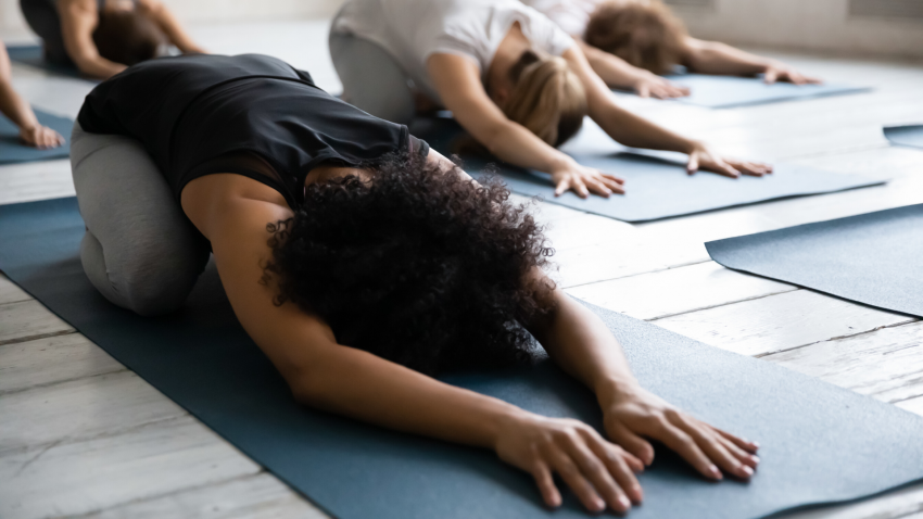 Woman practicing yoga for awareness in Child's Pose (Balasana)