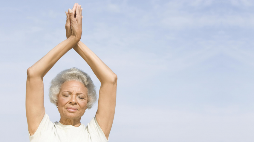 Older beginner yoga yoga student enjoying the benefits of meditation