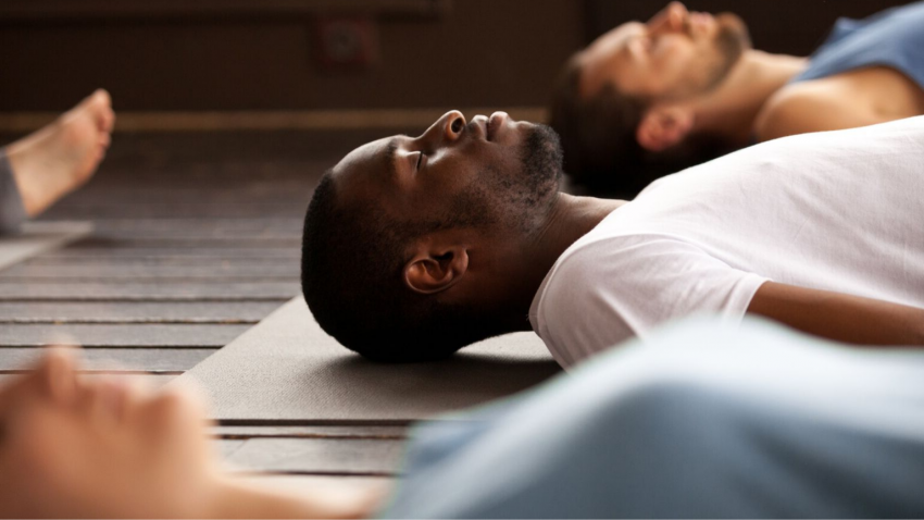 yoga men doing savasana