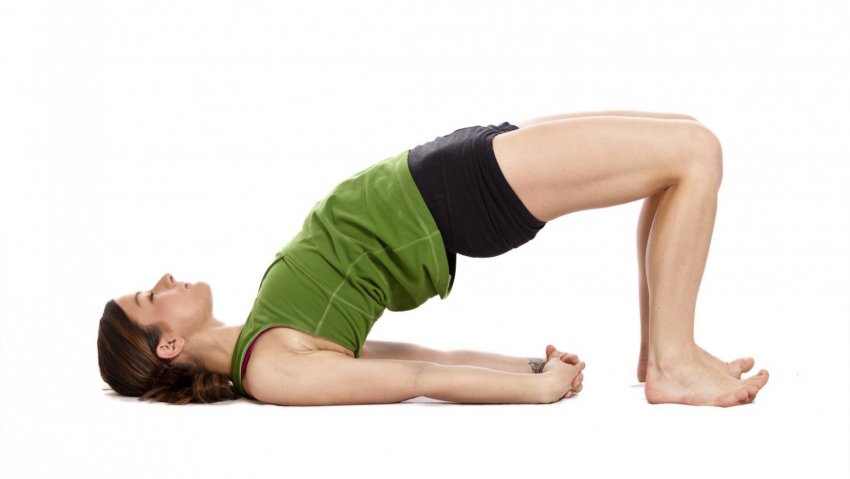 Woman in Bridge Pose (Setu Bandha Sarvangasana) to help have better posture Woman in Bridge Pose (Setu Bandha Sarvangasana) to help have better posture