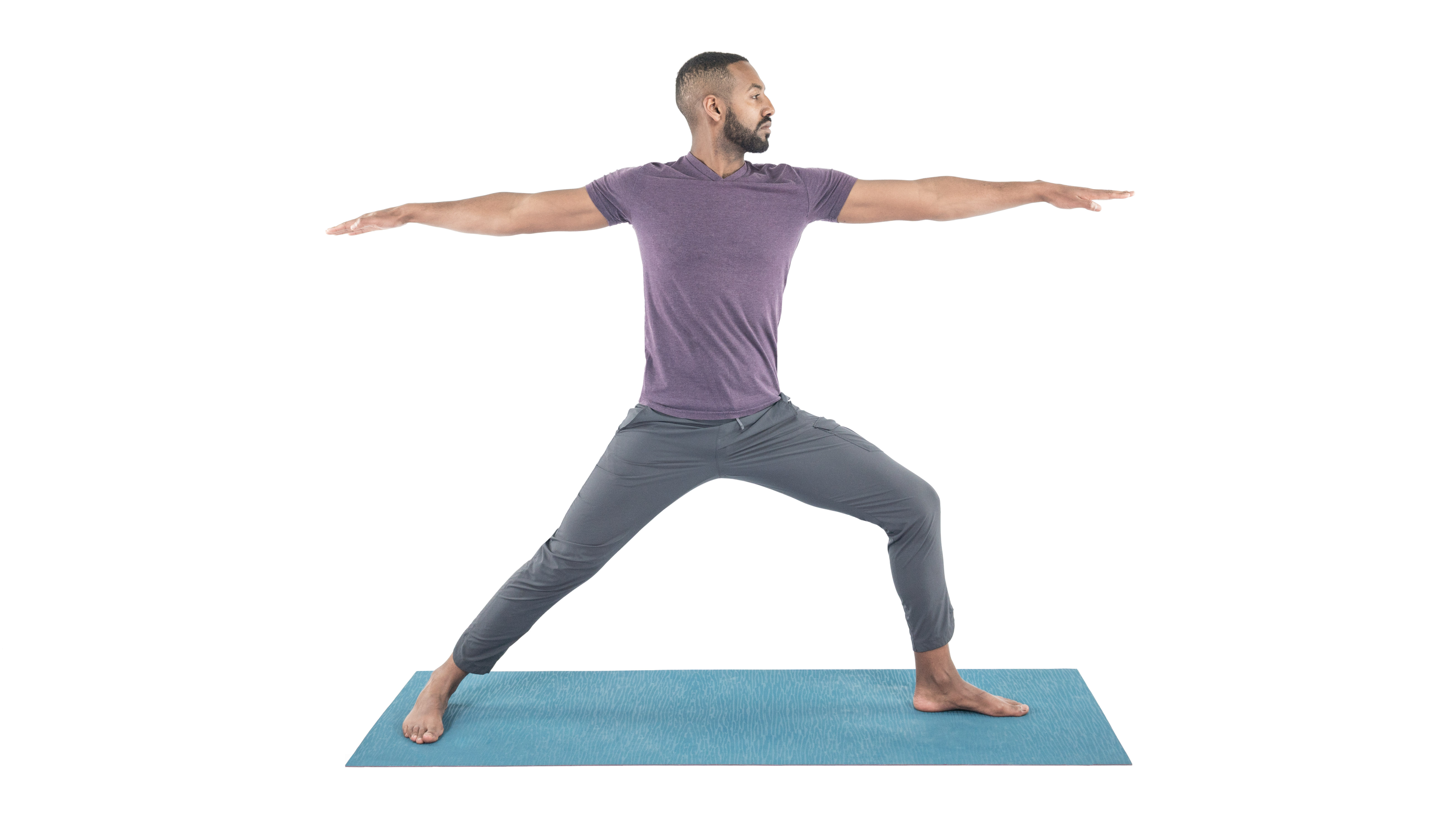 yoga man practicing virabhadrasana 2, warrior 2 pose
